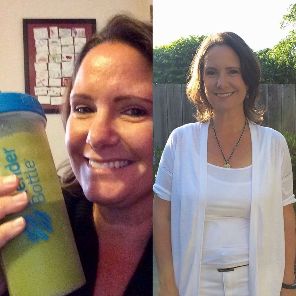 Two women are smiling and holding a drink.